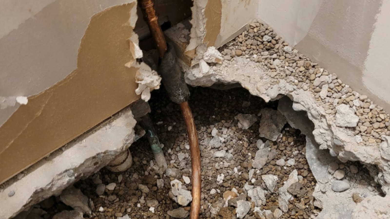 Exposed residential supply piping during a floor repair